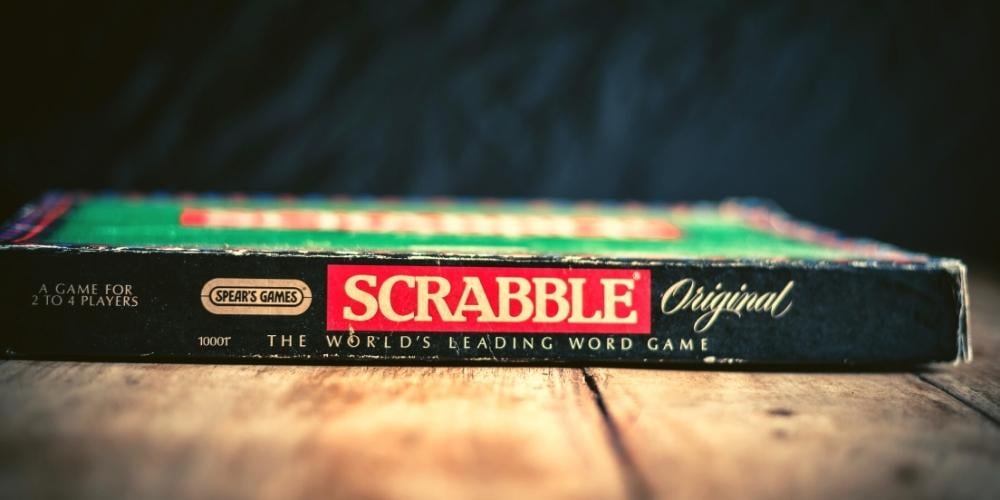 Picture of a Scrabble box on a table. Scrabble is a fun game to play with older people.