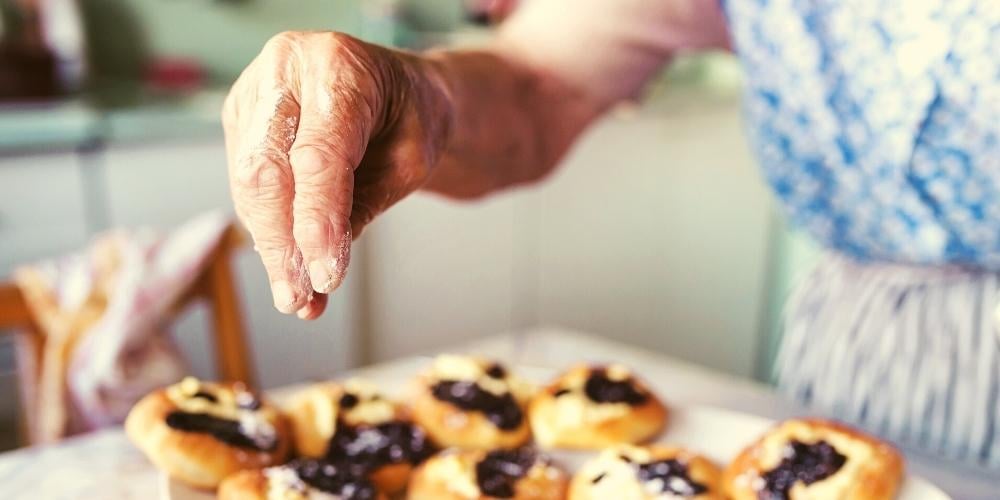 A photo of an elderly dementia patient enjoying cooking and baking.