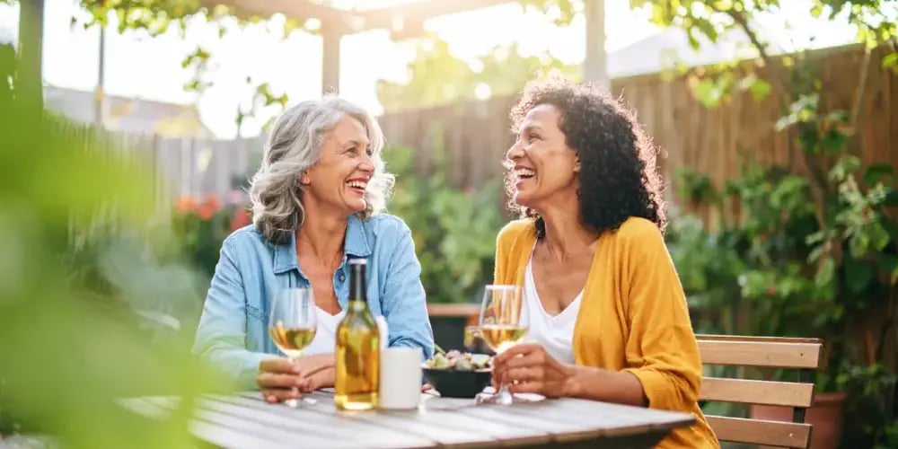 Two friends enjoy social connection and leisure time together, a vital self-care strategy for family caregivers to prevent burnout and support their mental health.