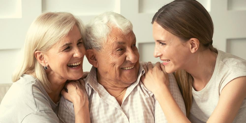 A family (elderly father, mother and youthful daughter) sharing a joke. 